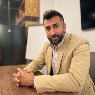 Abdullah AlBasha sitting at a table, ready for a conversation